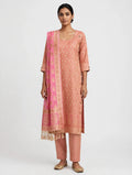 A three-piece suit in dusty rose peach